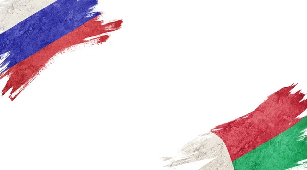 Прапори Росії та Мадагаскару на білому тлі — стокове фото